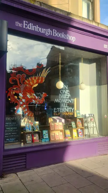 The Edinburgh Bookshop window with a large Phoenix painted on the glass, to mark the publication of ELif Shafak's In One Brief Moment, All Eternity