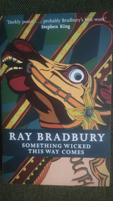 paperback of Something Wicked This Way Comes, with a disturbing looking merry-go-round horse on the cover